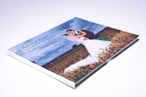 Wedding photo album showing a bride and groom embracing in a field, with the names Jain and Louise on the cover.
