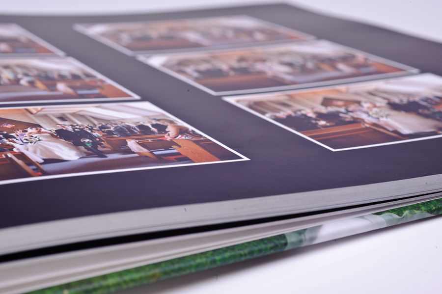 D3A_9226-copy | Weddings by Michael Close-up of a photo album page showing several printed photos with white borders on a dark page.